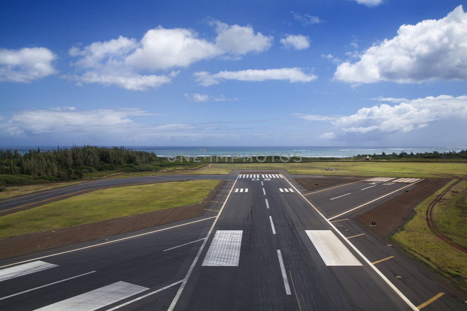 Aerial view of airport runway on coastline of Maui, Hawaii.