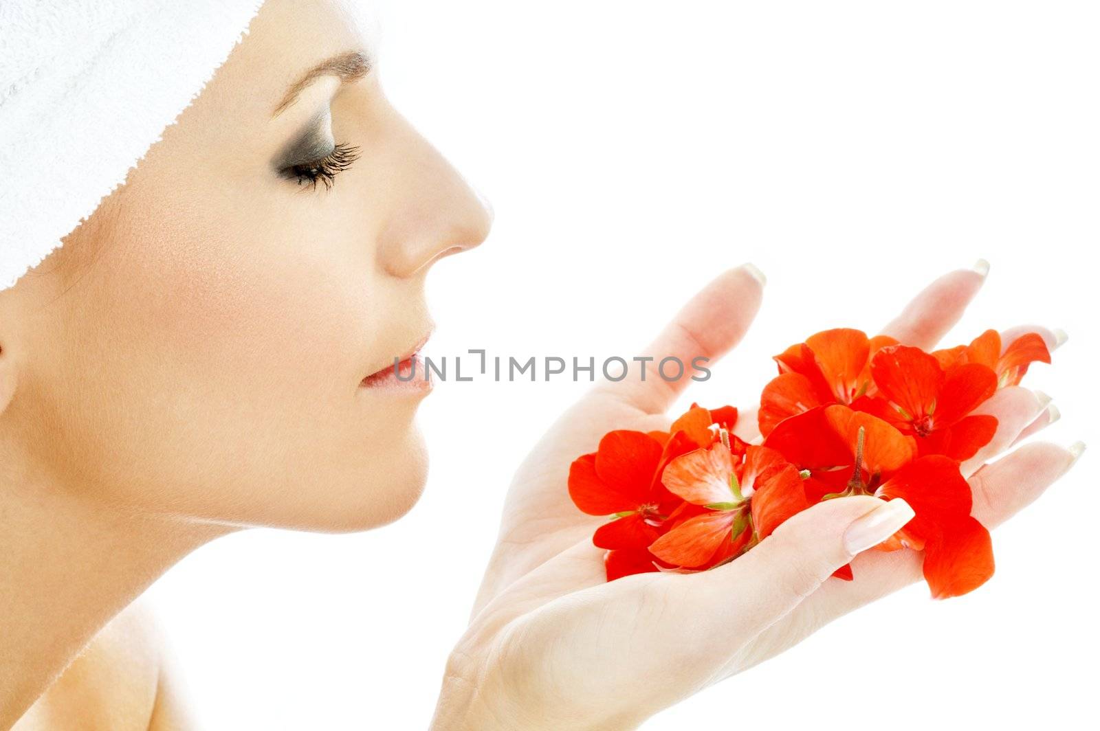 lovely woman with red flower petals in spa