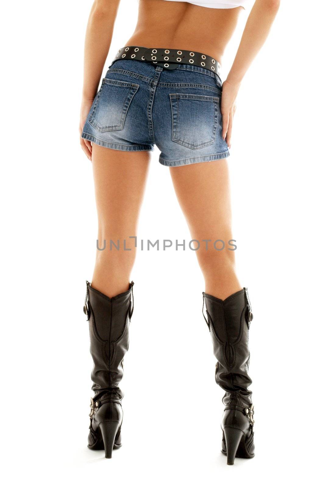long legs in cowboy boots and denim shorts over white