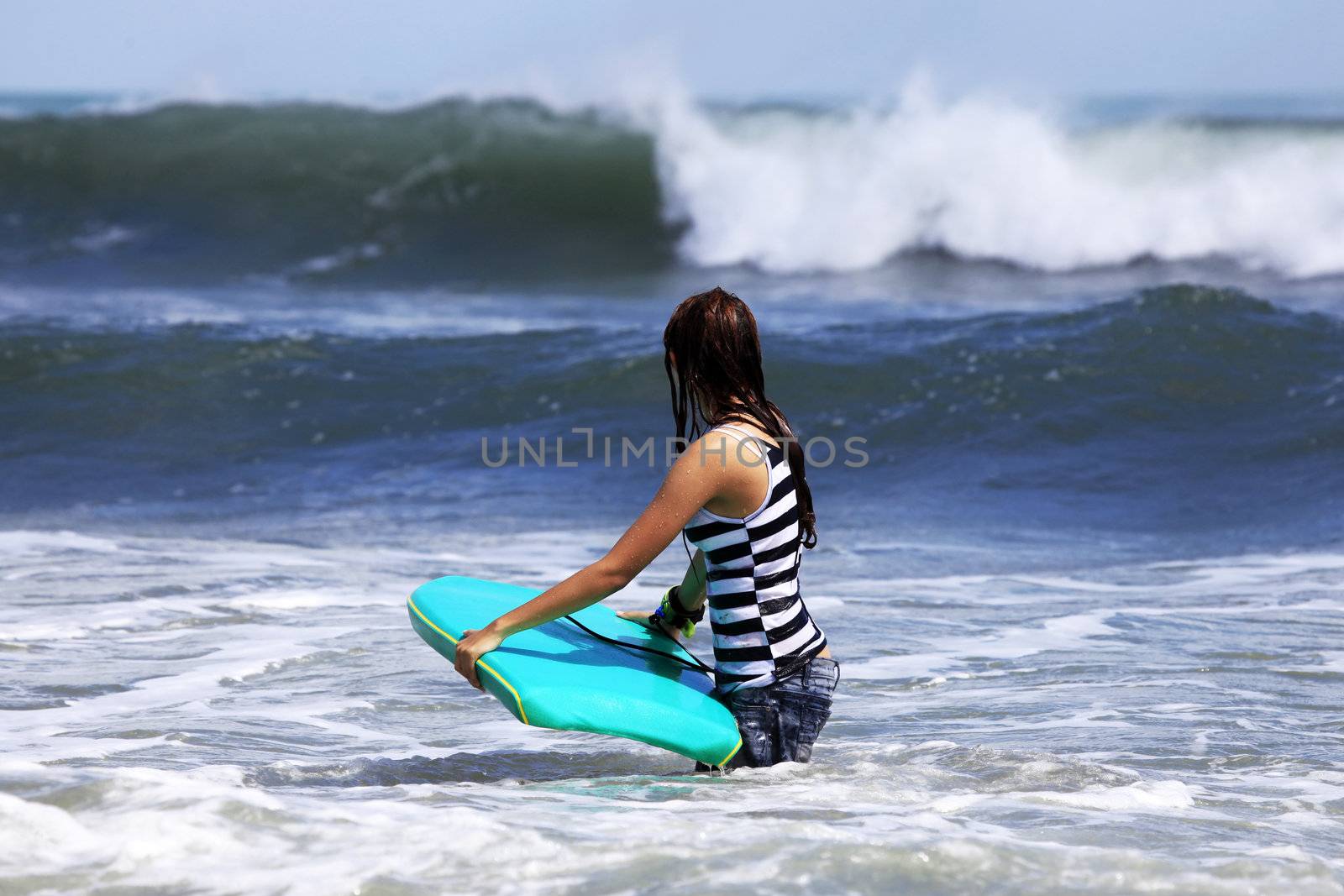 Gilr - the surfer in ocean. Bali. Indonesia