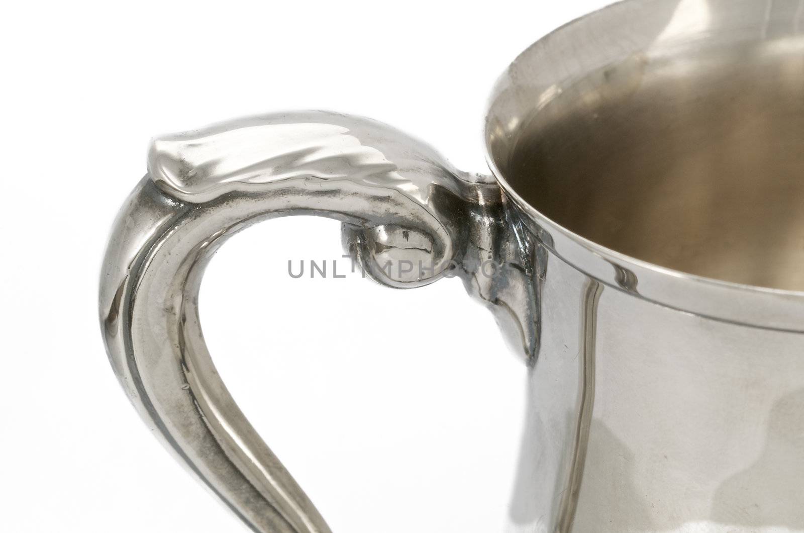 Handle detail on antique silver mug