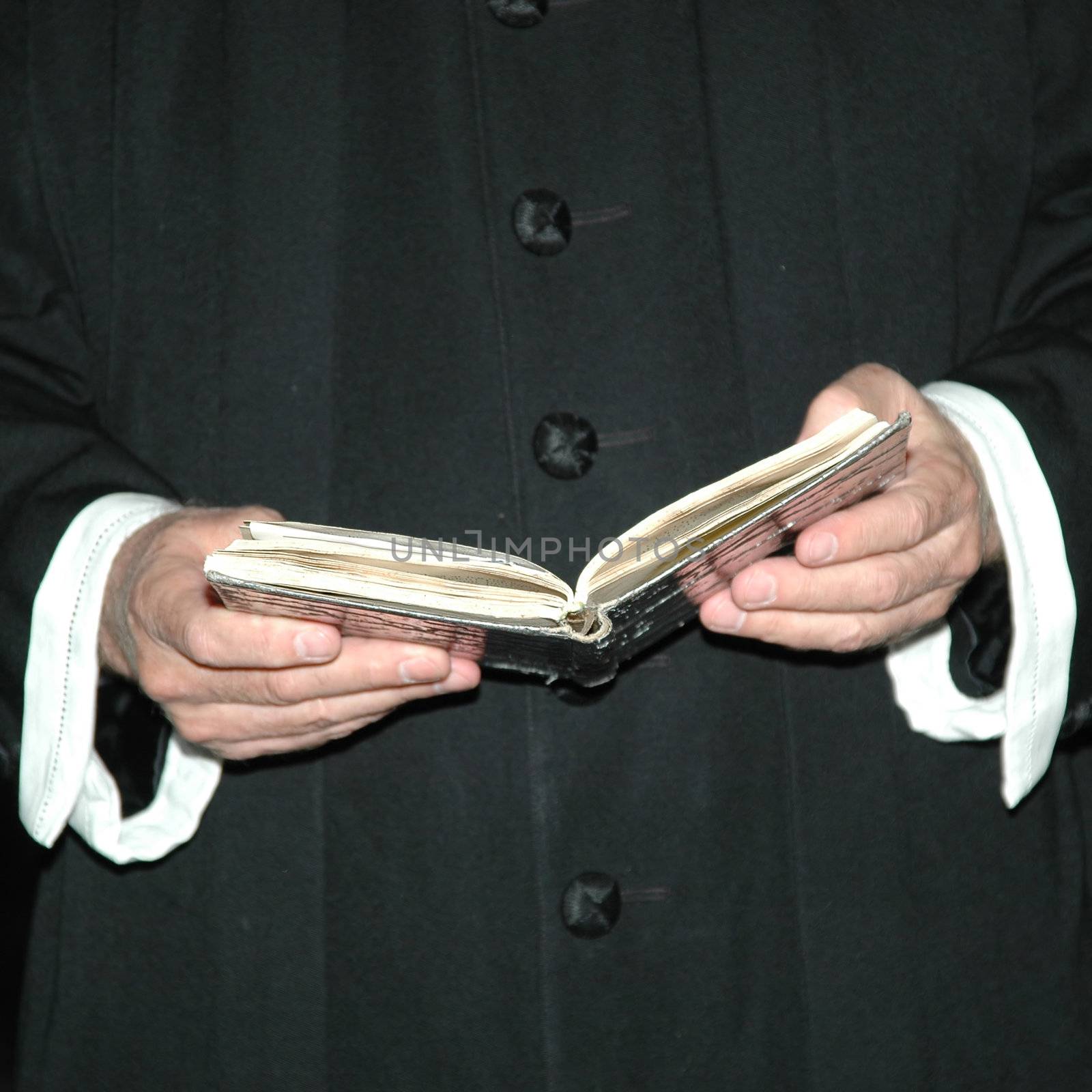 Priest and bible by cfoto