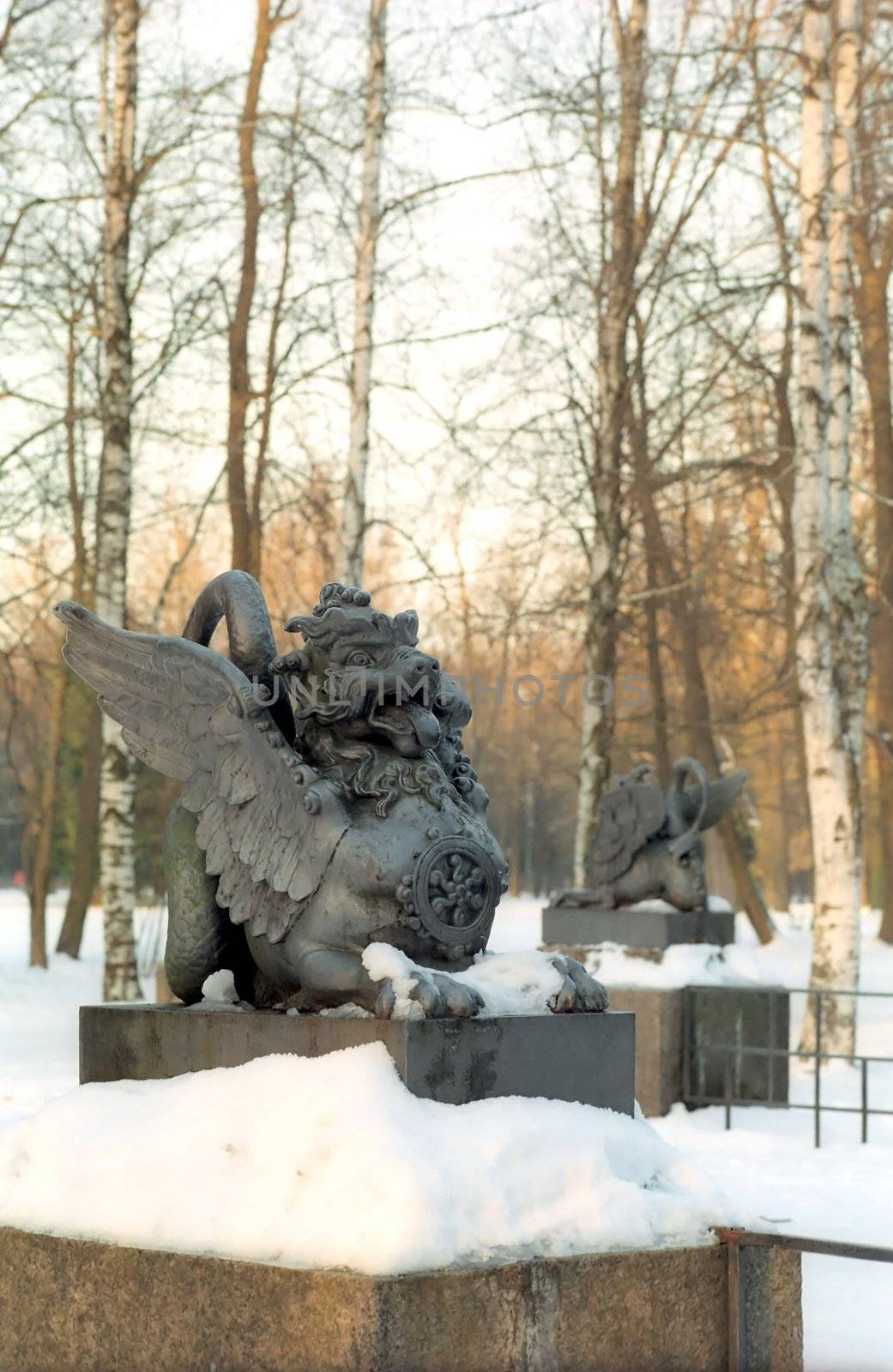 Old metal chinese dragons in winter snow park  