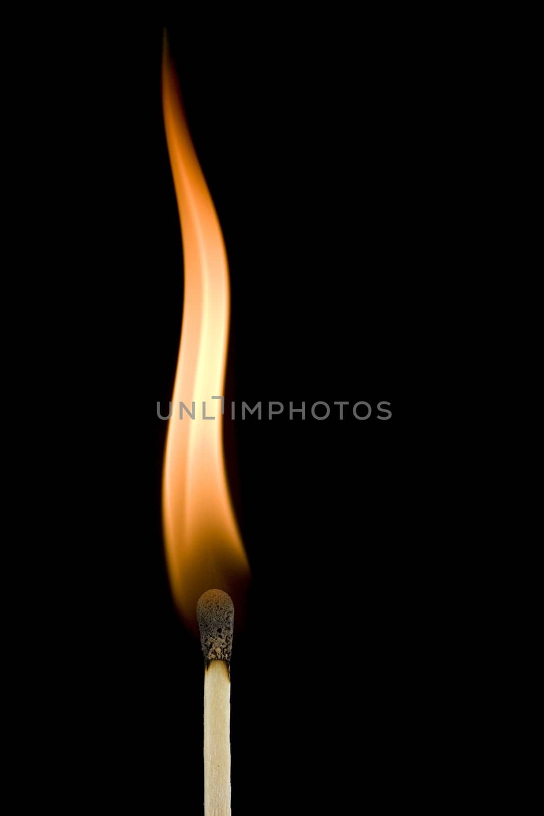Macro of a burning matchstick flame in the dark