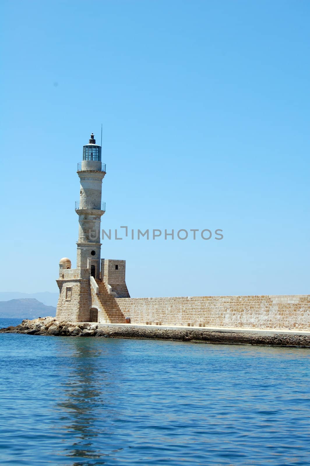 lighthouse in the old port of chania by mojly