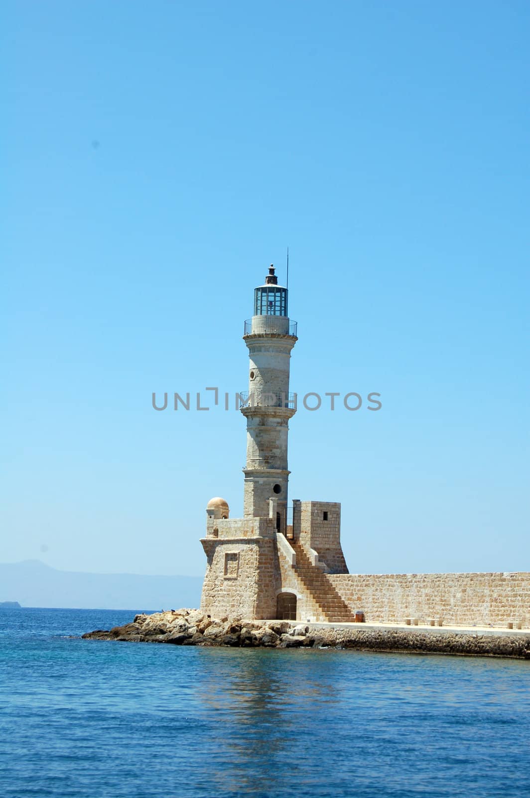 lighthouse in the old port of chania by mojly
