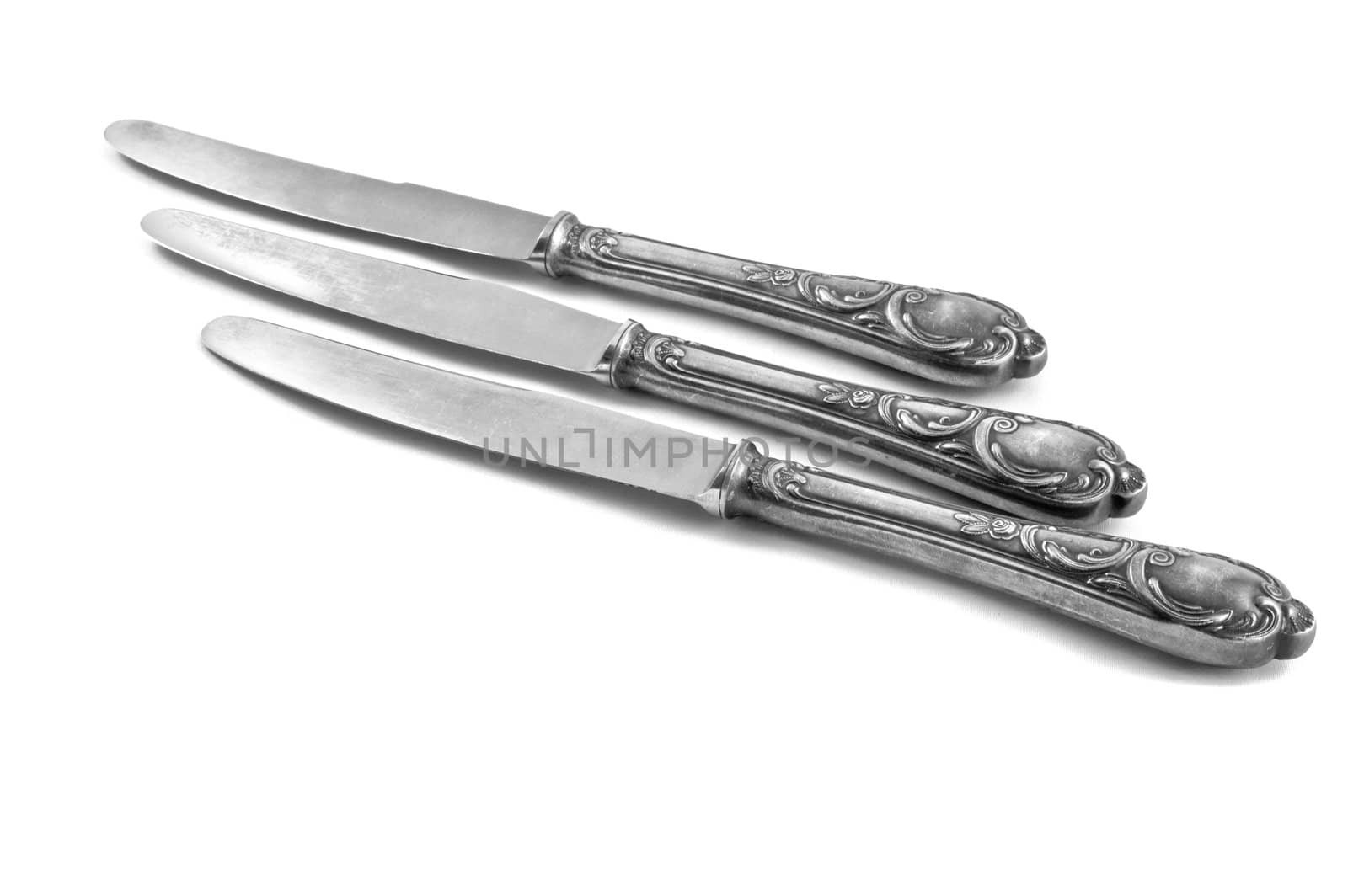 three table knifes on white background by galcka