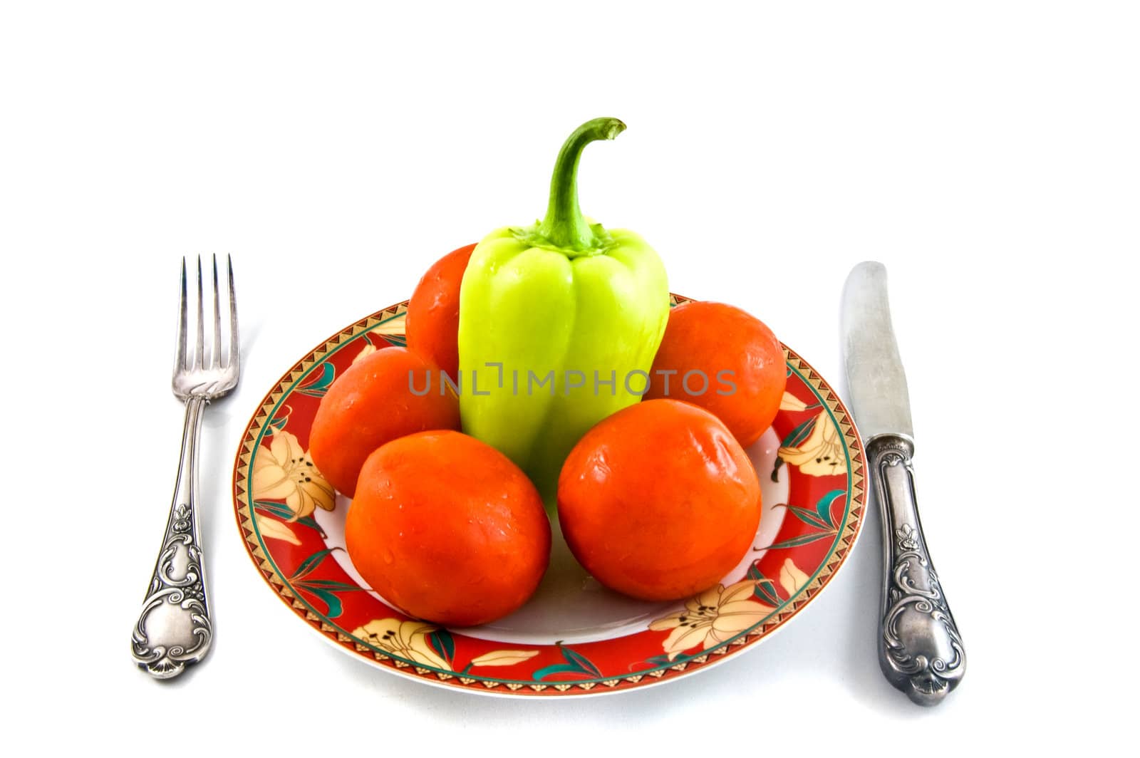 peppers and tomatoes on plate on white bacground