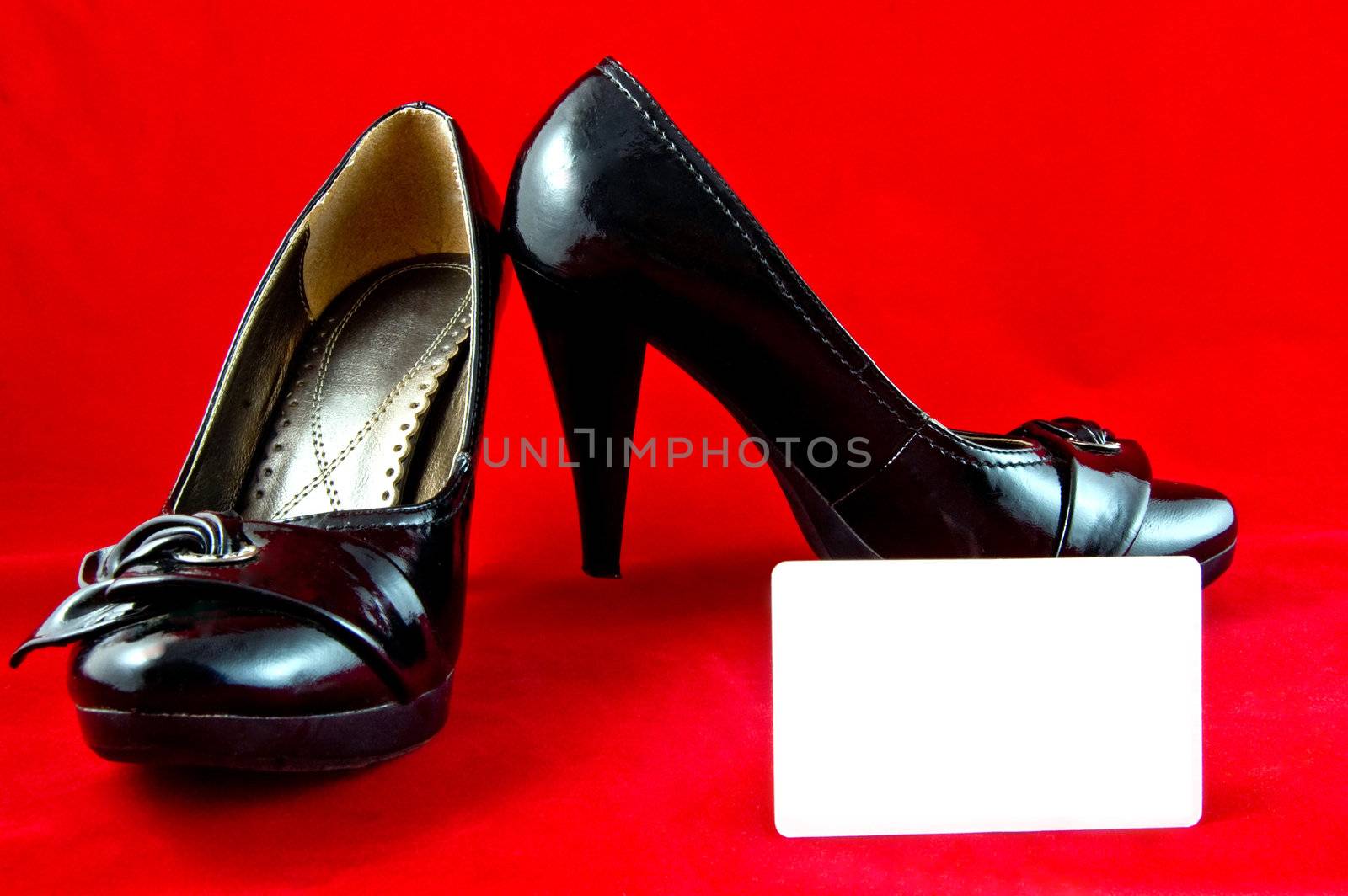 black shoes and card on red background  by galcka