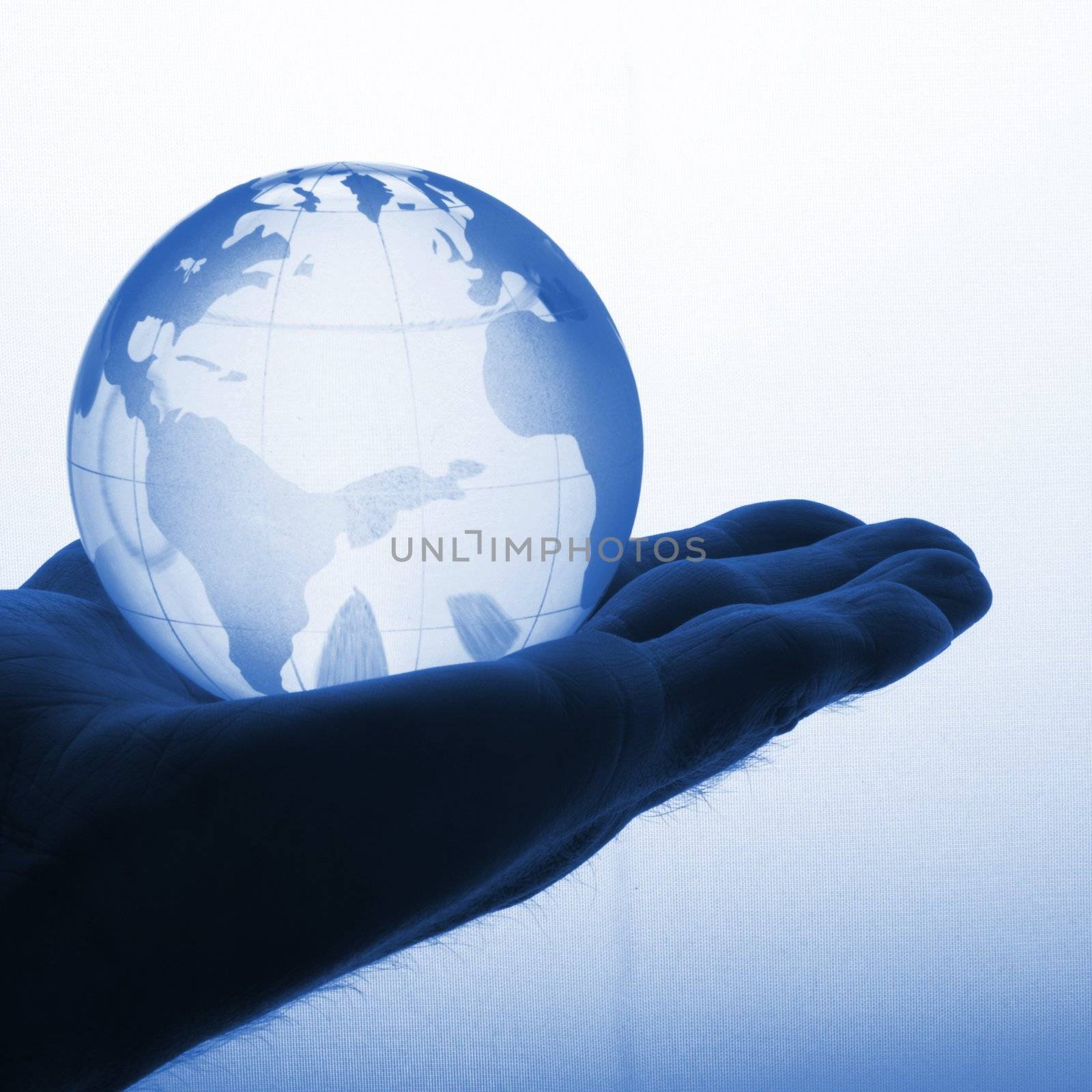 hand holding globe to protect the fragile environment