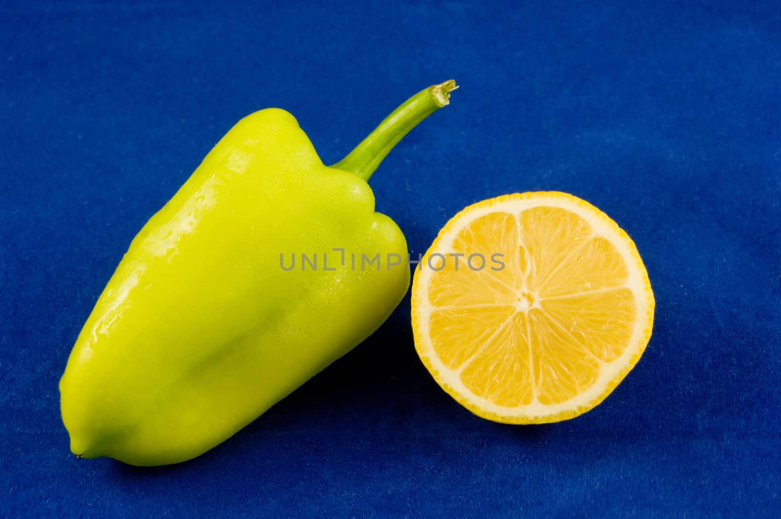 green pepper and lemon on blue bacground