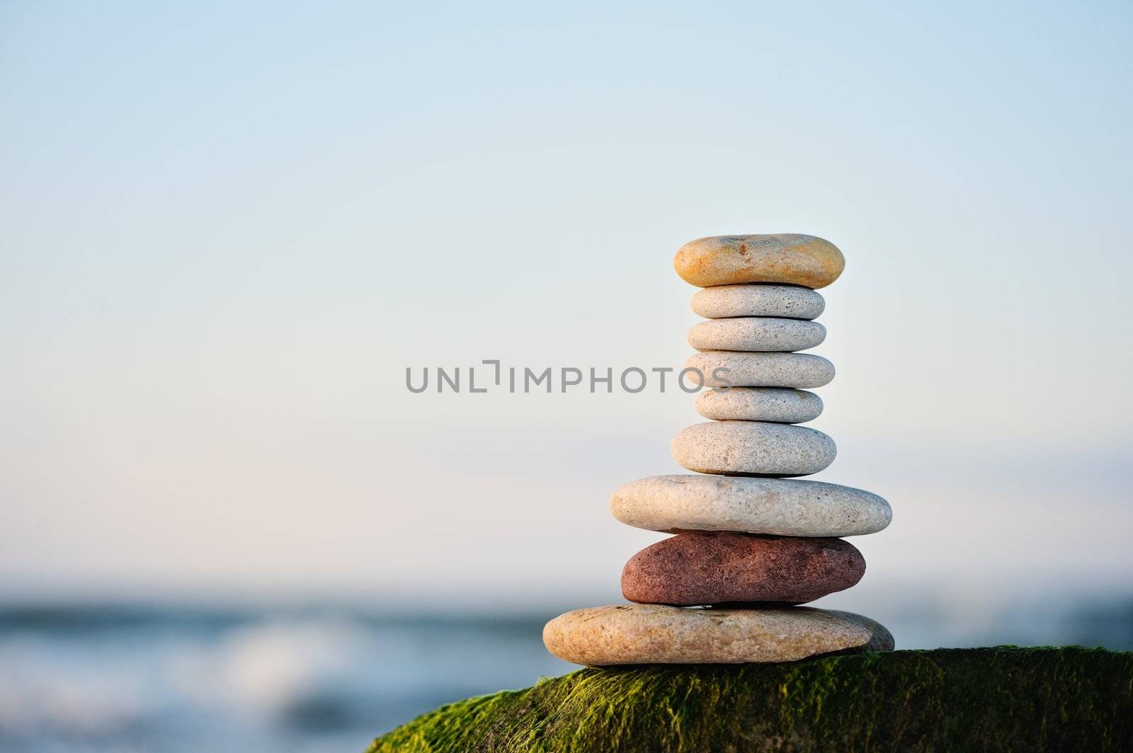 Pile from a sea pebble on a beach early in the morning