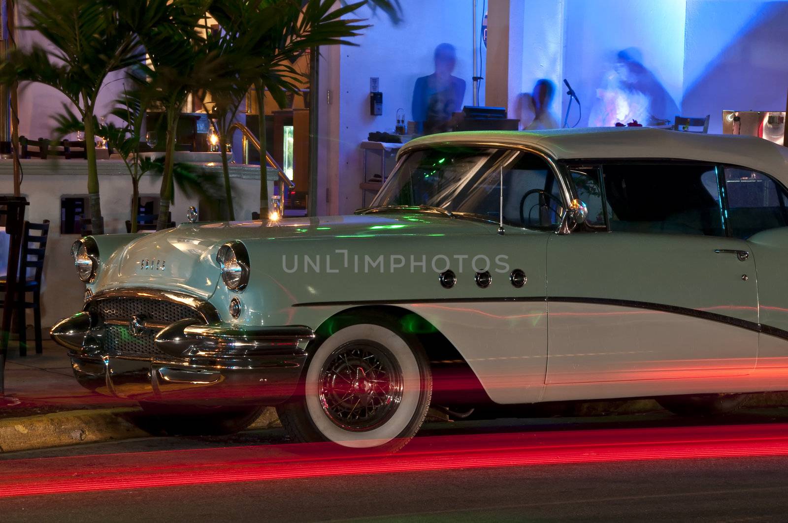 Antique Car Parked on Ocean Drive, Miami Beach Art Deco District at Night.