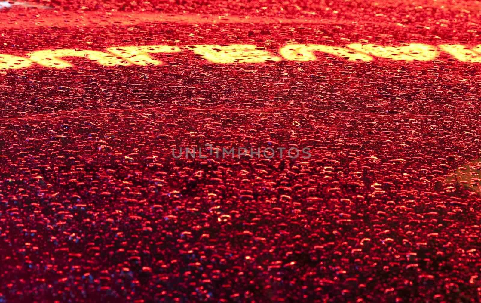 Close up of drops and sign reflection on a glass after raining in Miami Beach