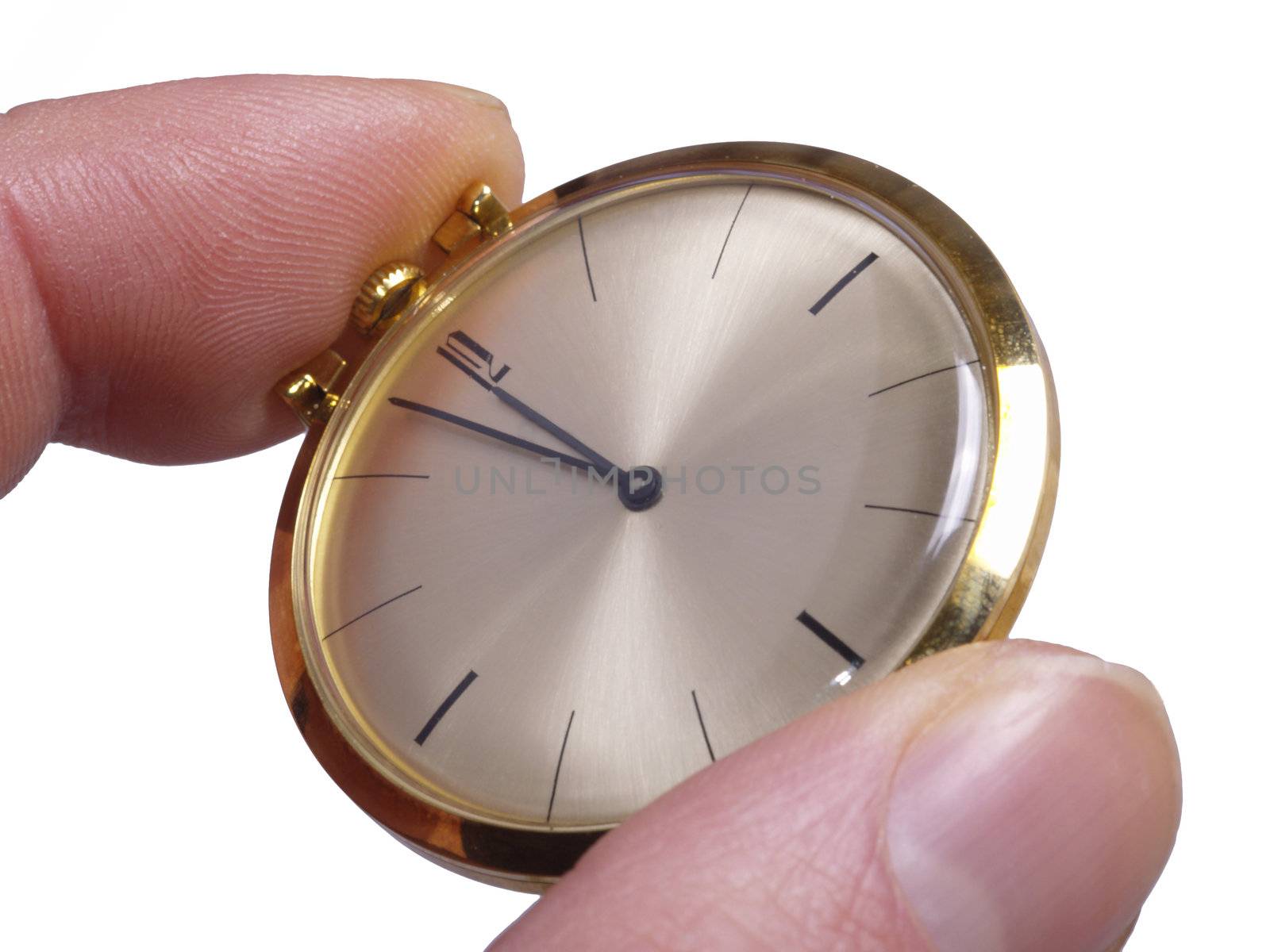 Fingers holding gold pocket Watch, isolated