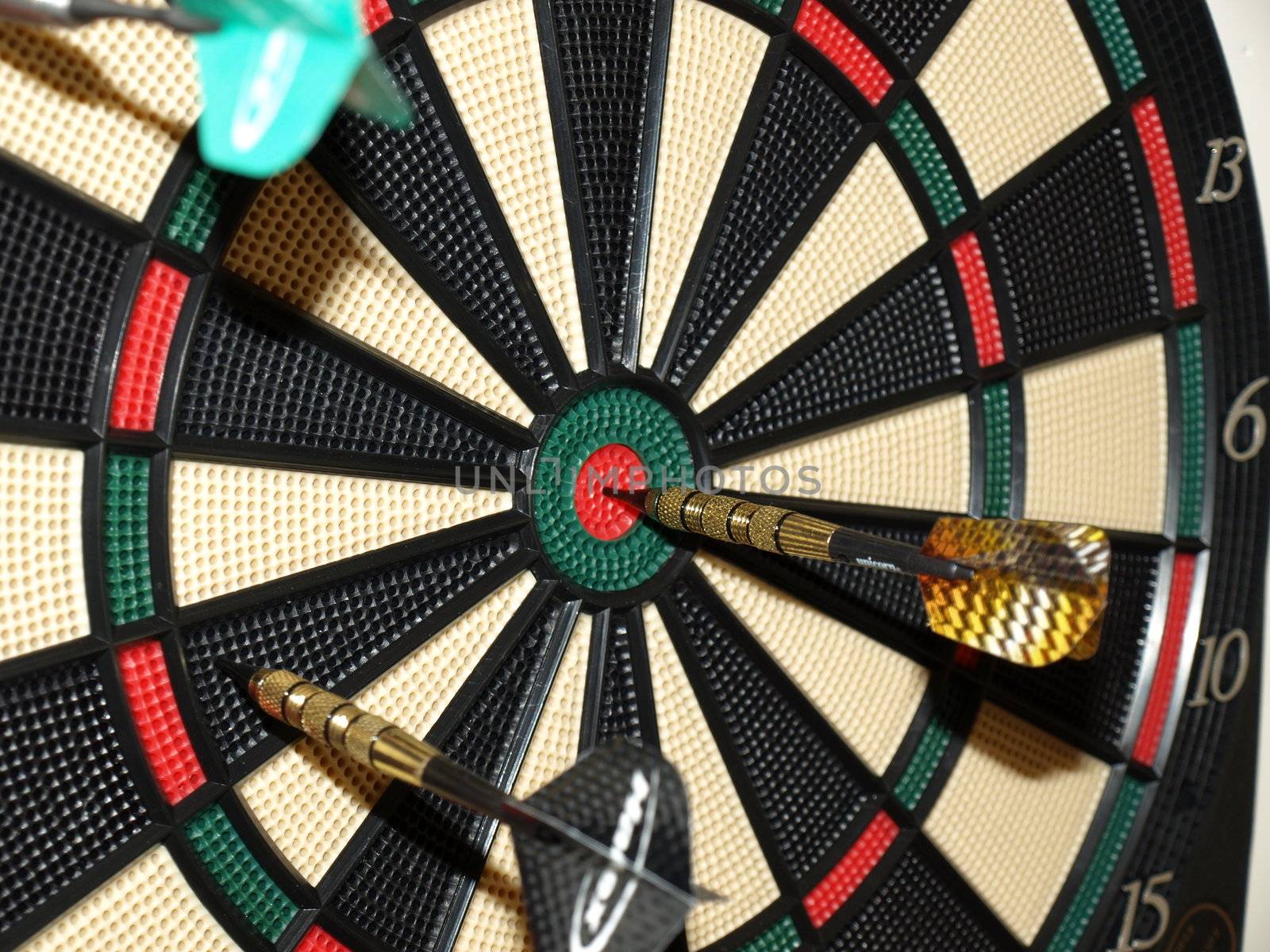 Darts thrown at the board with one bullseye