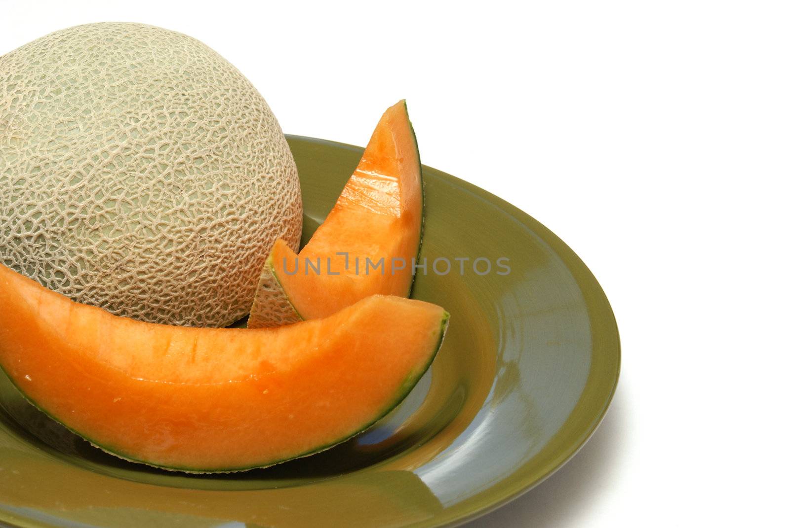 A freshly sliced cantaloupe on a plate.