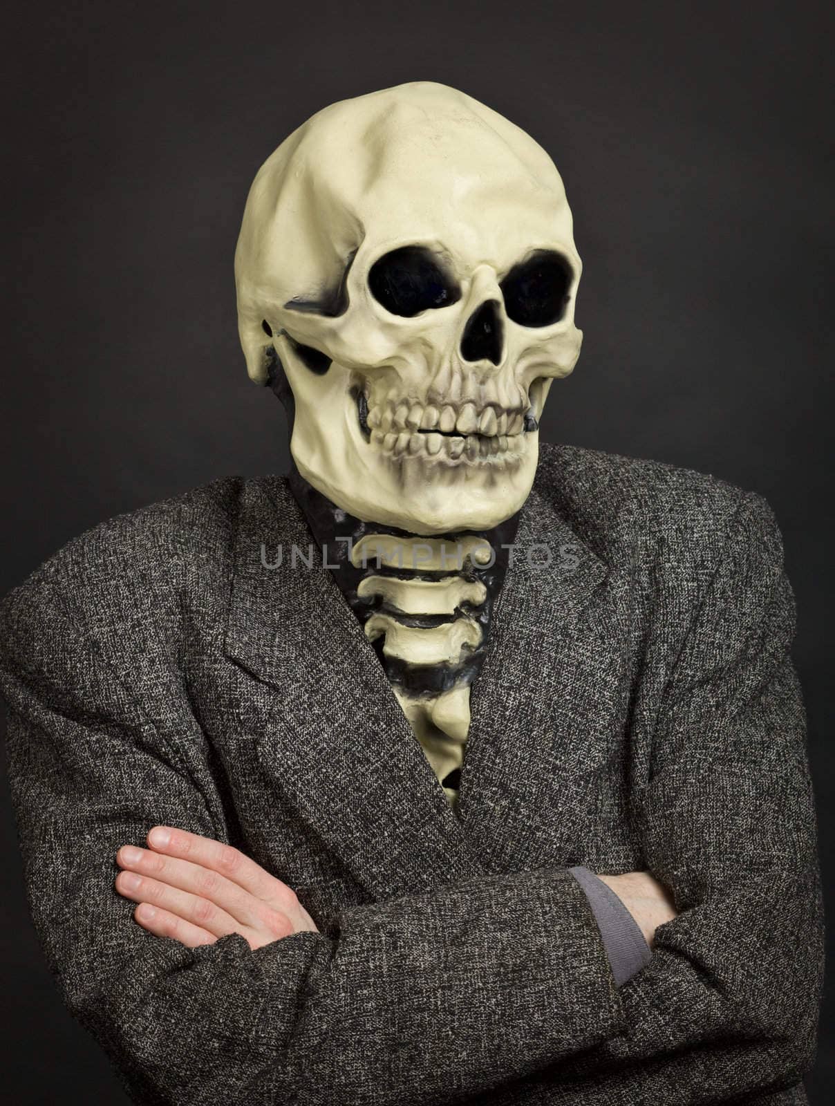 Portrait of the person in a skeleton mask against a dark background
