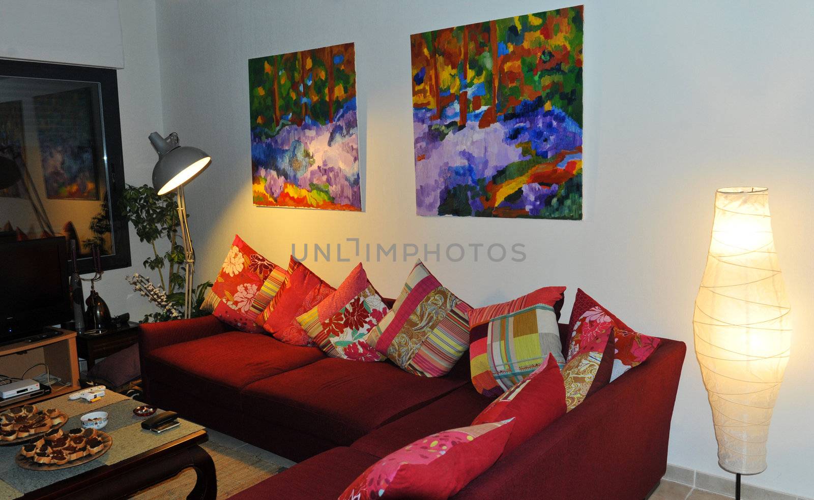interior cosy with red sofa and pictures on the wall