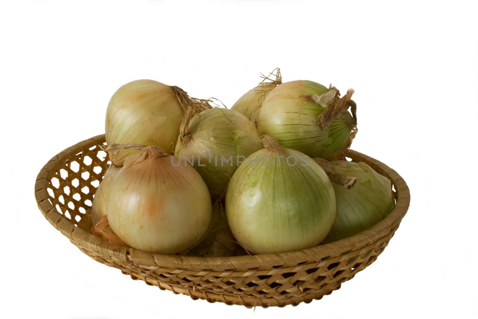 New onion in wicker wooden vase in isolated over white