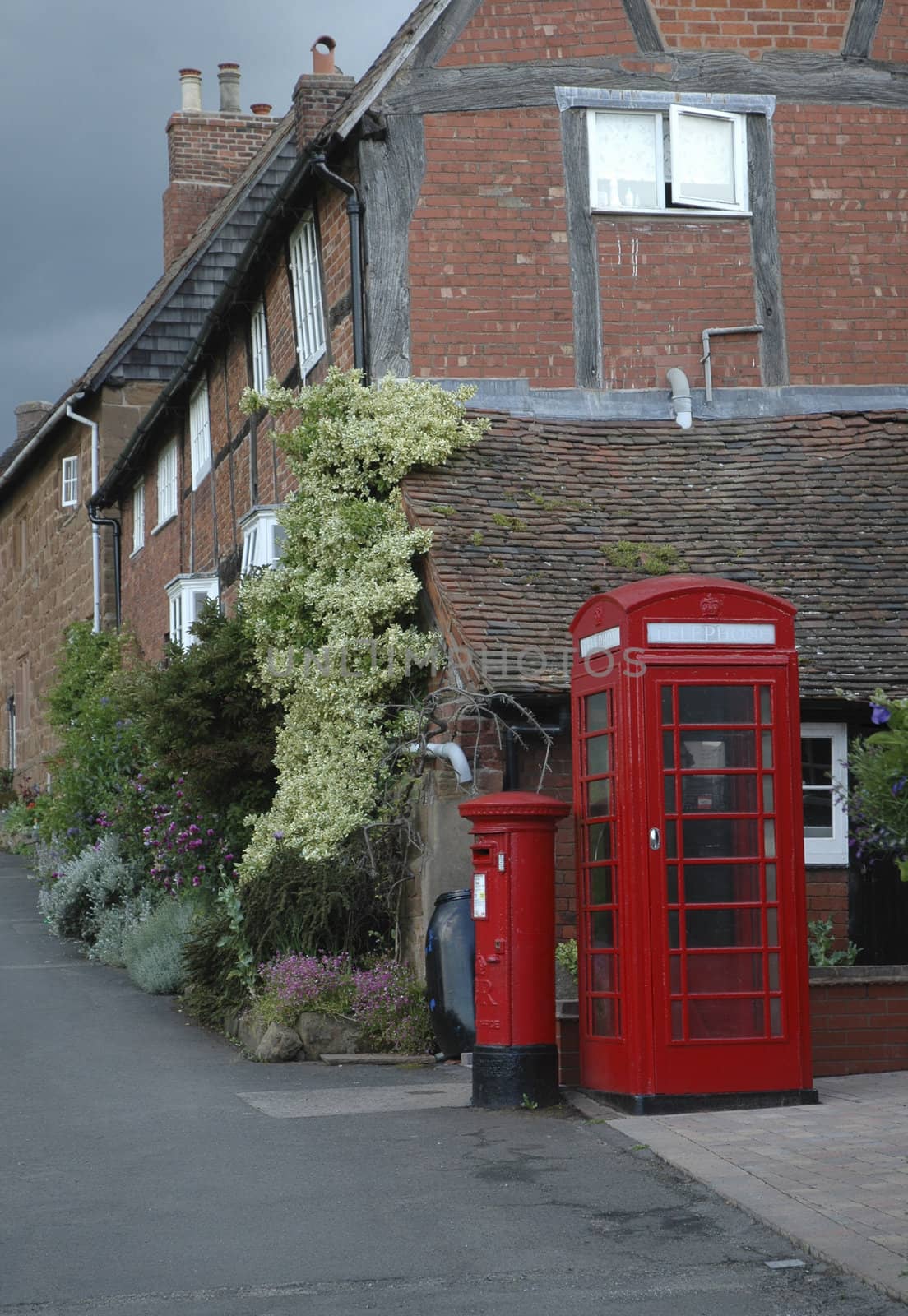 Old village scene with houses, telephone and postbox