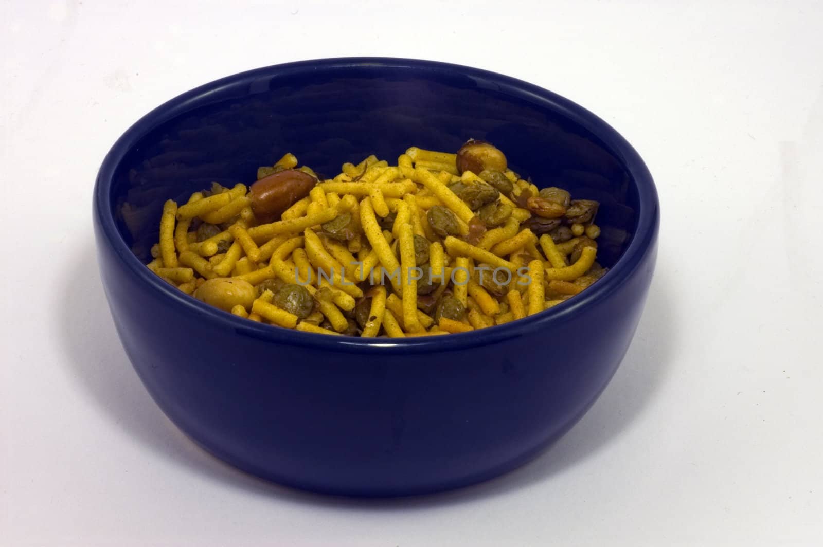A blue bowl containing Bombay Mix snack
