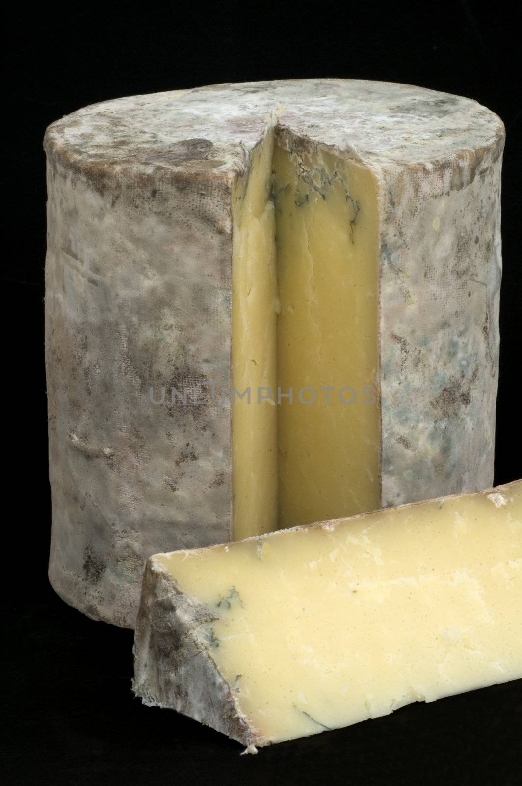 A full cheddar cheese matured in Somerset Caves with a slice cut out