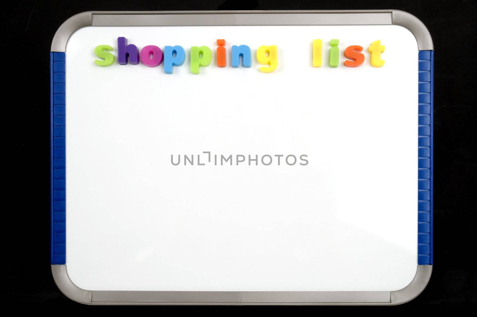 A magnetic board with colourful letters spelling shopping list