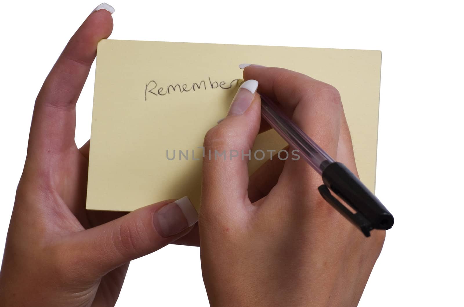 Female Hand writing Remember on Sticky note