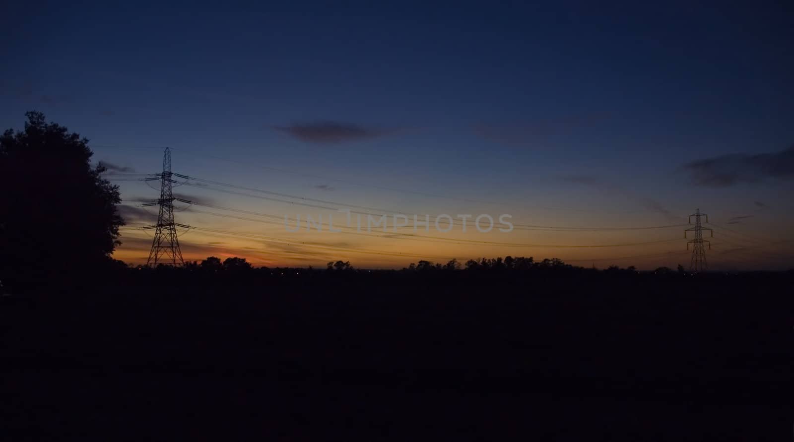 Pylons and power lines at sunset