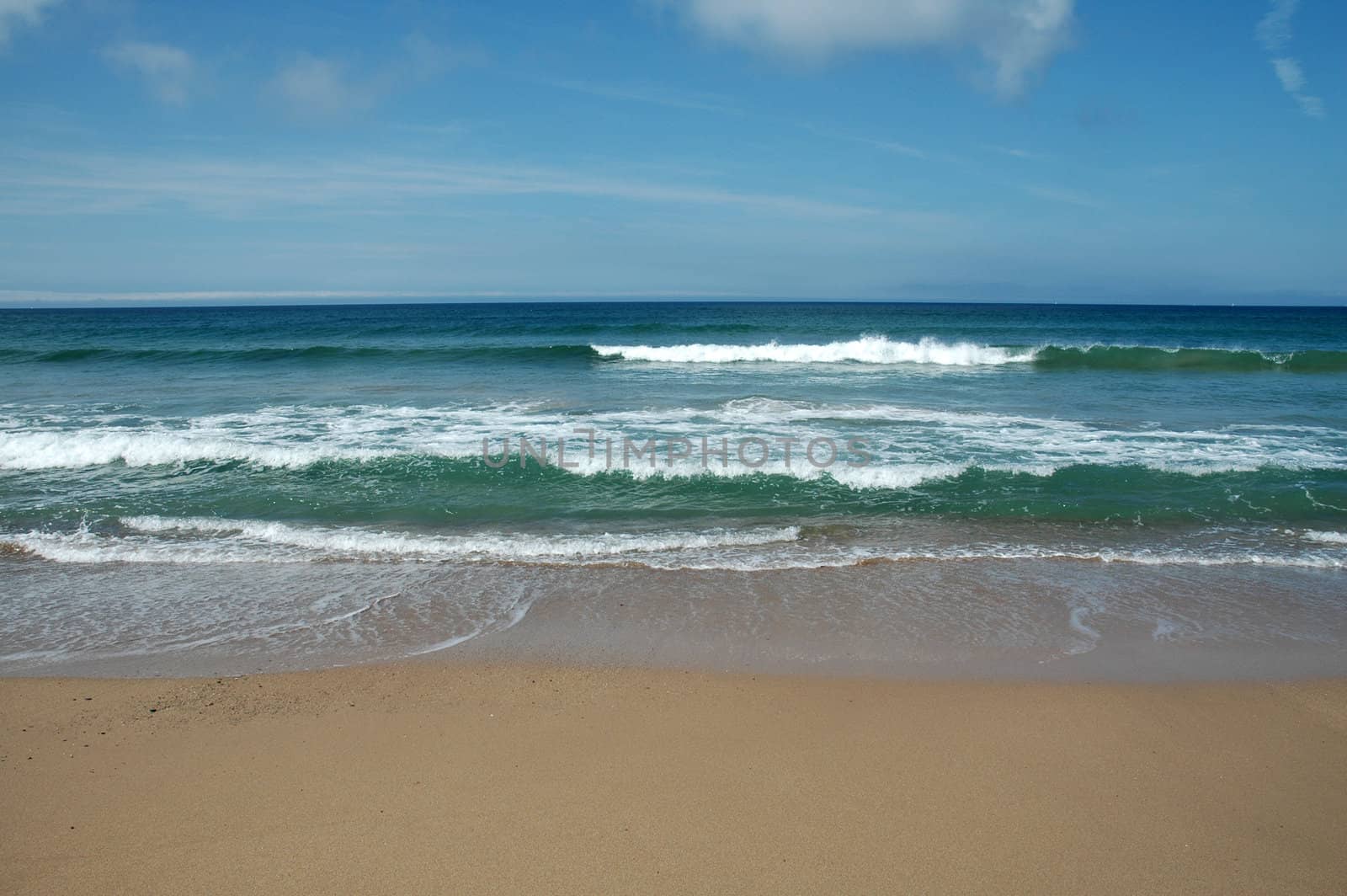 a sandy beach with sea and sky