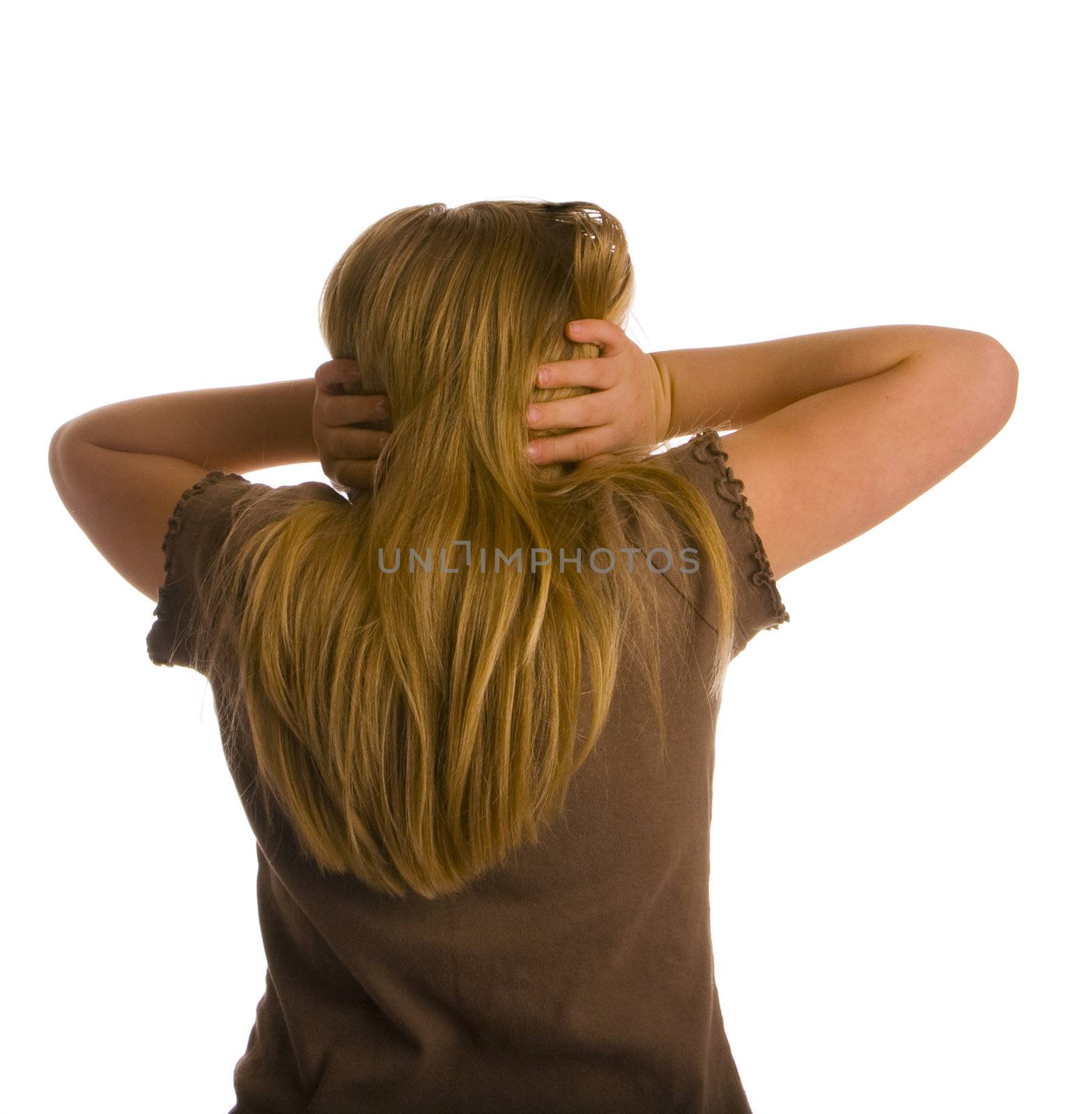 A girl with her back turned and ears covered.