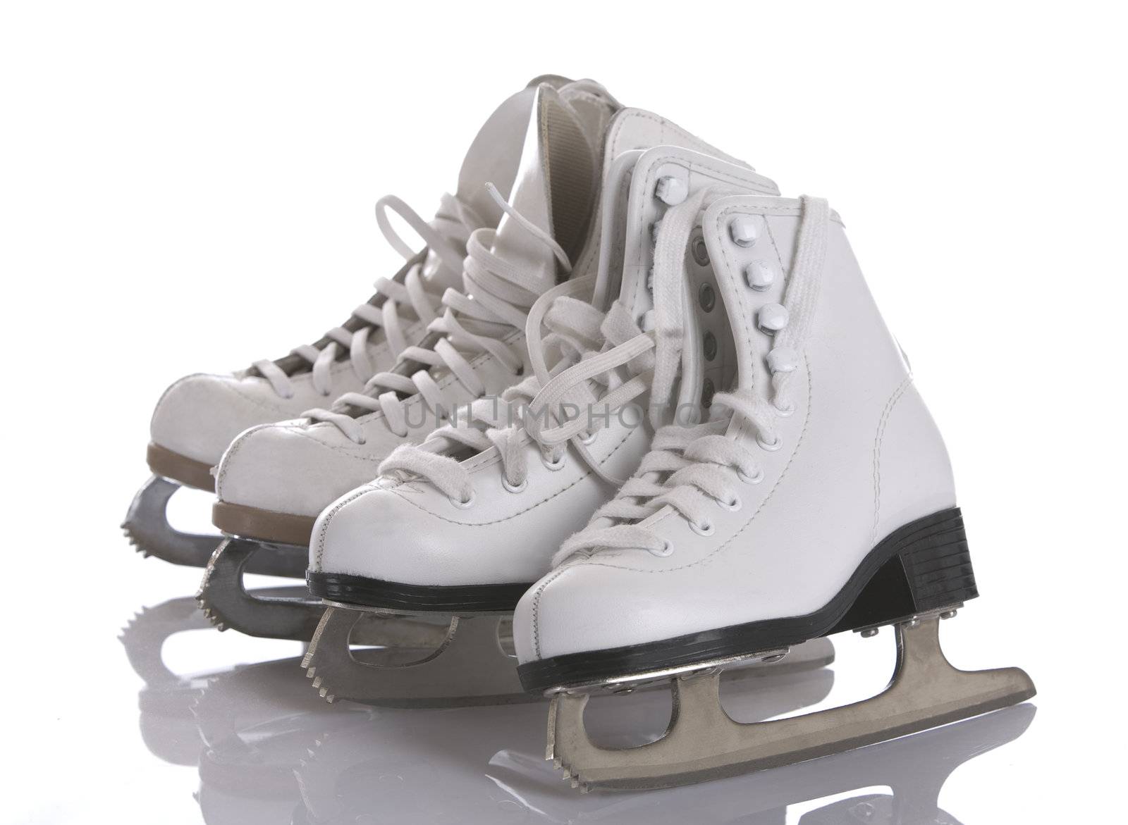 Four figures skates on white and ice background