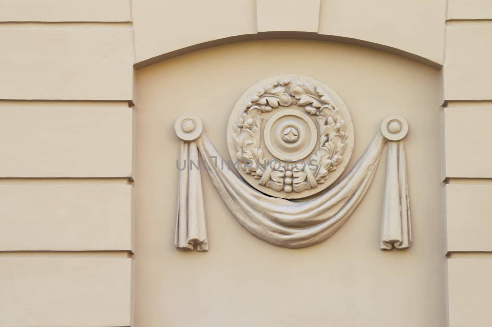 A close-up detail of a building facade decor. A moulded plastic panel. Early soviet-epoch style.