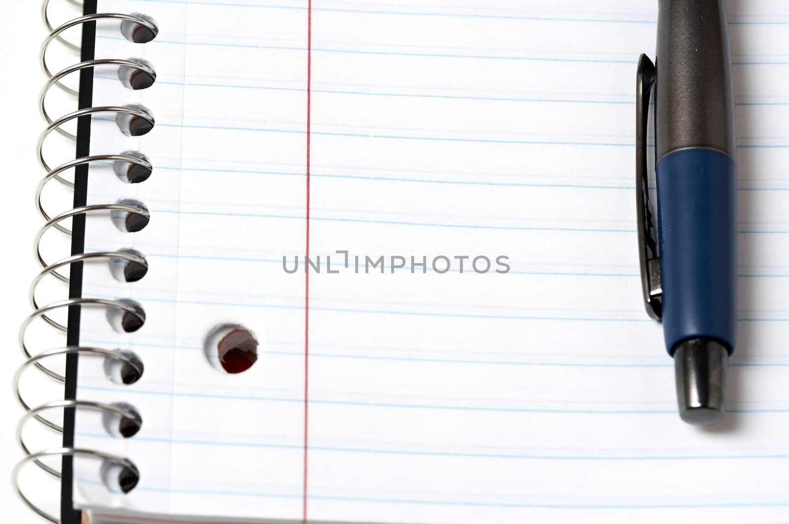 a macro picture of a pen and notebook