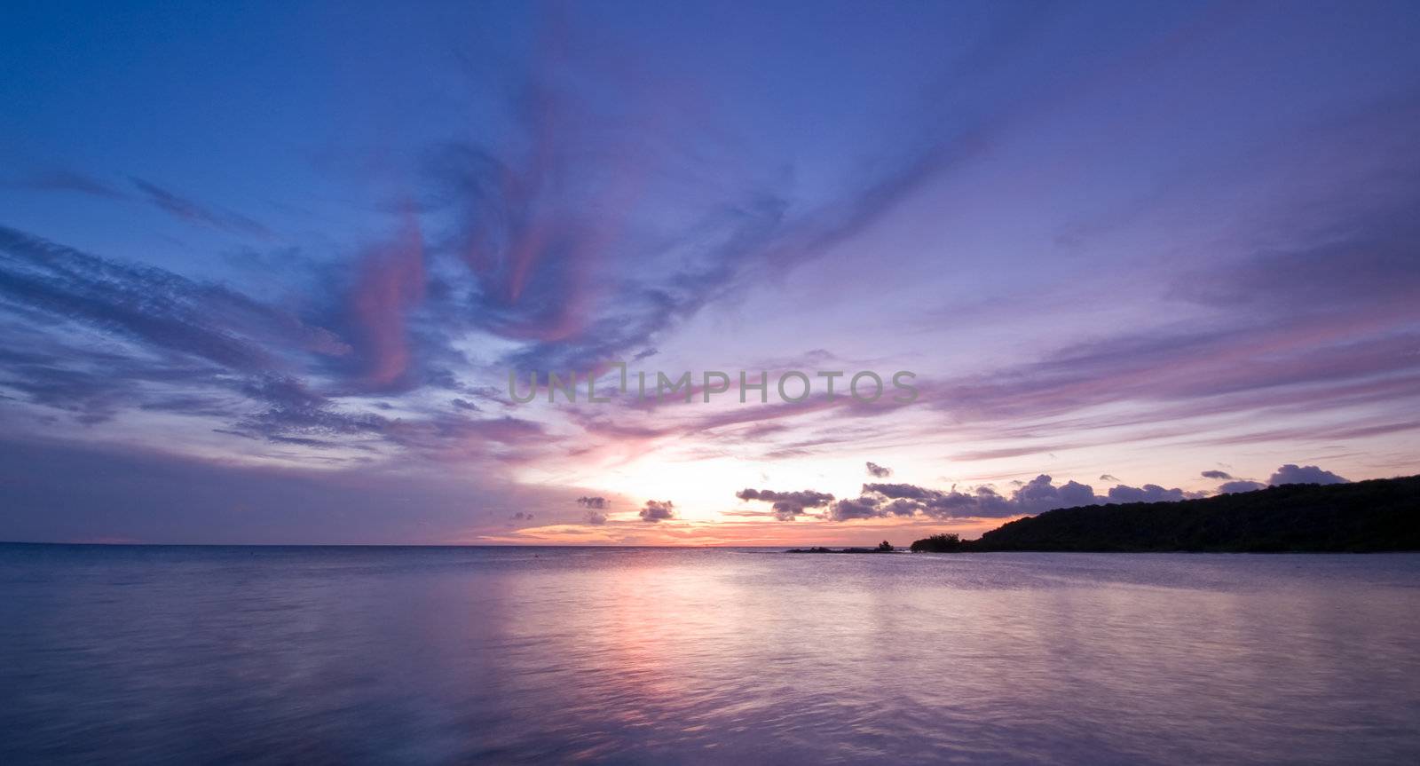 nice pastel blue sea sunset with sun disappear in the sea
