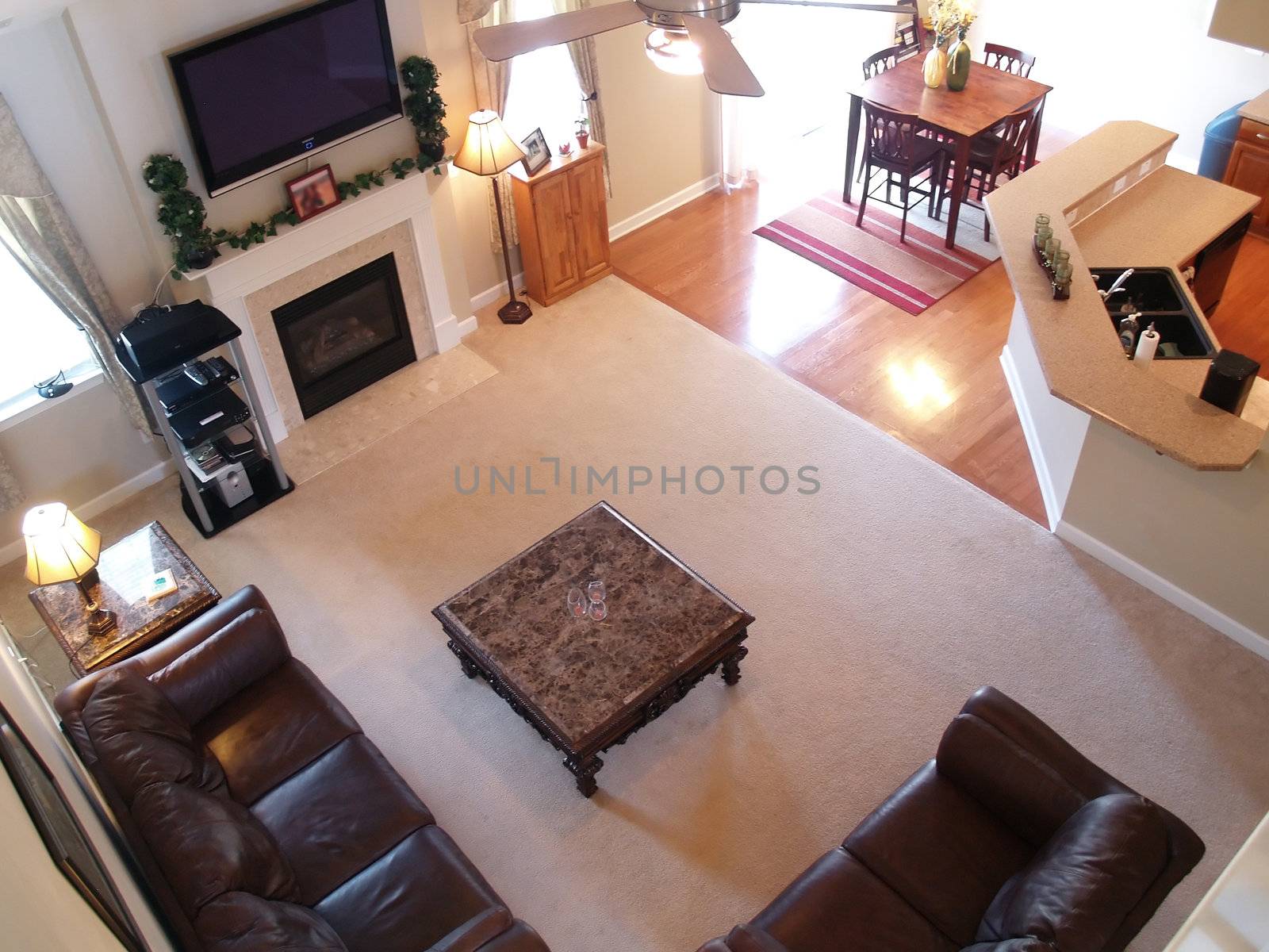 View of a well furnished family room and kitchen from an overhead walkway