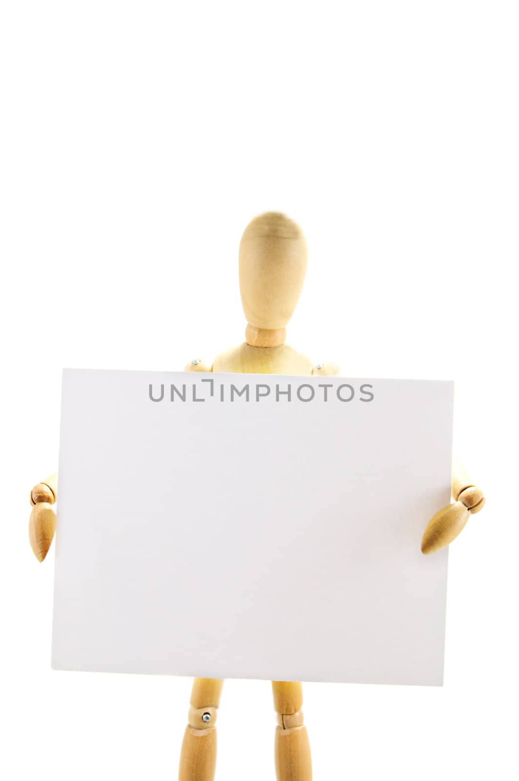 Wooden mannequin holding blank note on white background