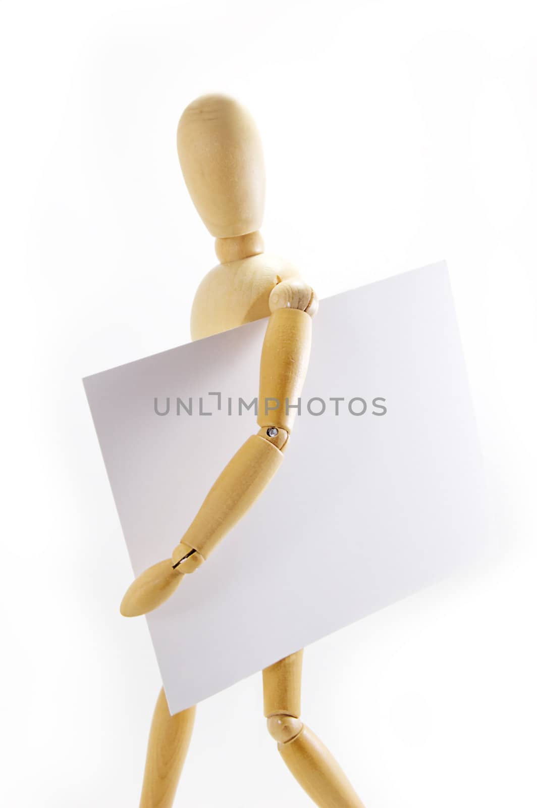 Wooden mannequin holding blank note under arm on white background