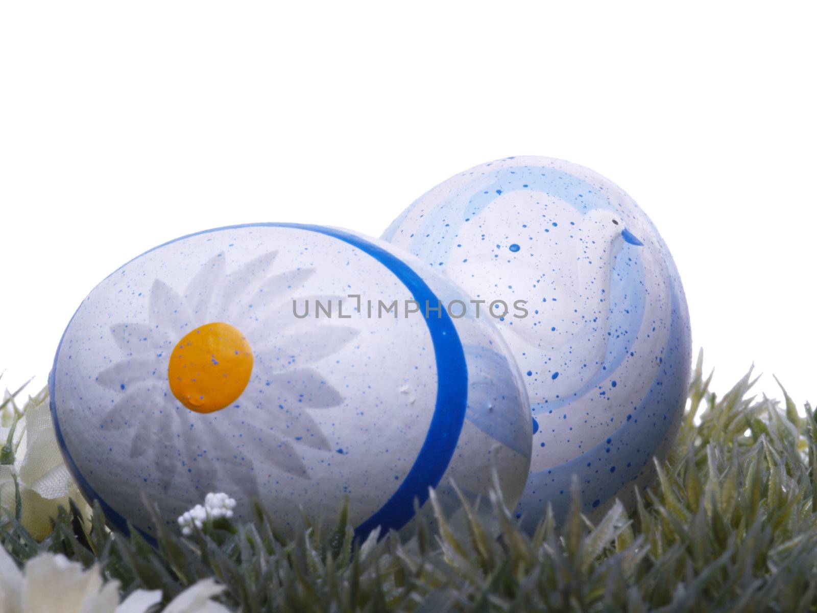 handpainted easter eggs, artificial grass and blossoms, isolated