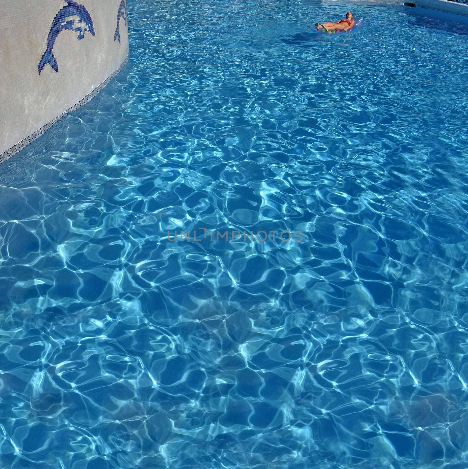 swimming pool with a woman on airbed