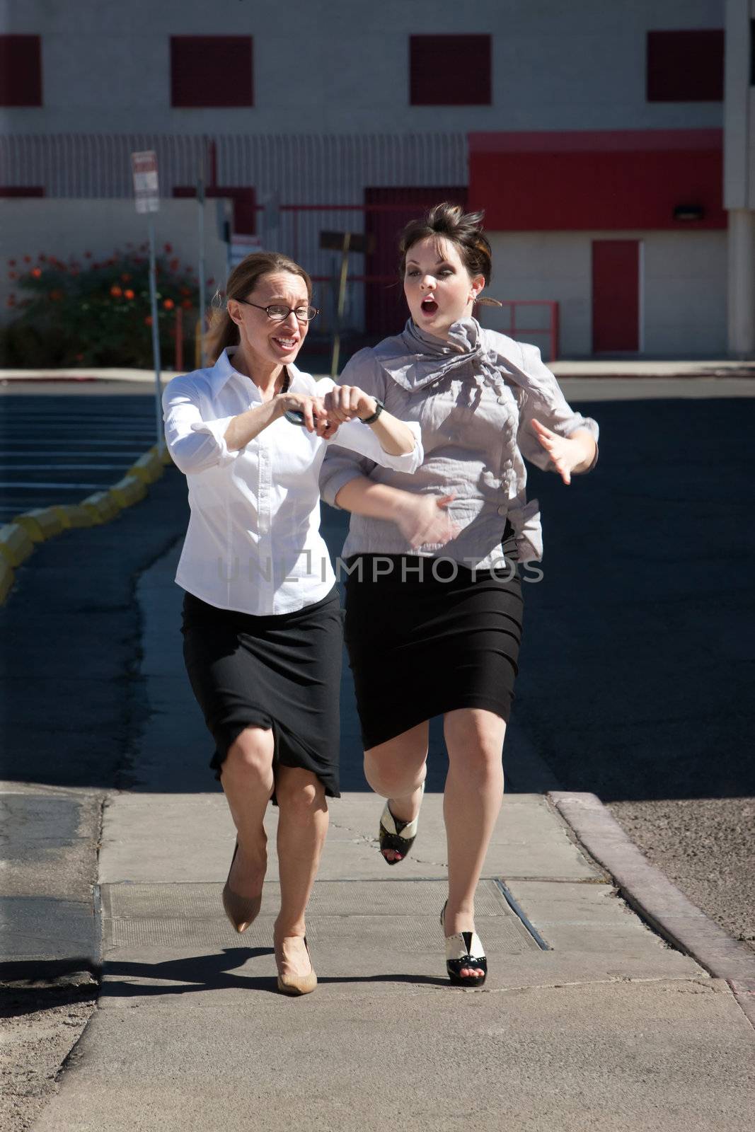 Two women are late for work and running.