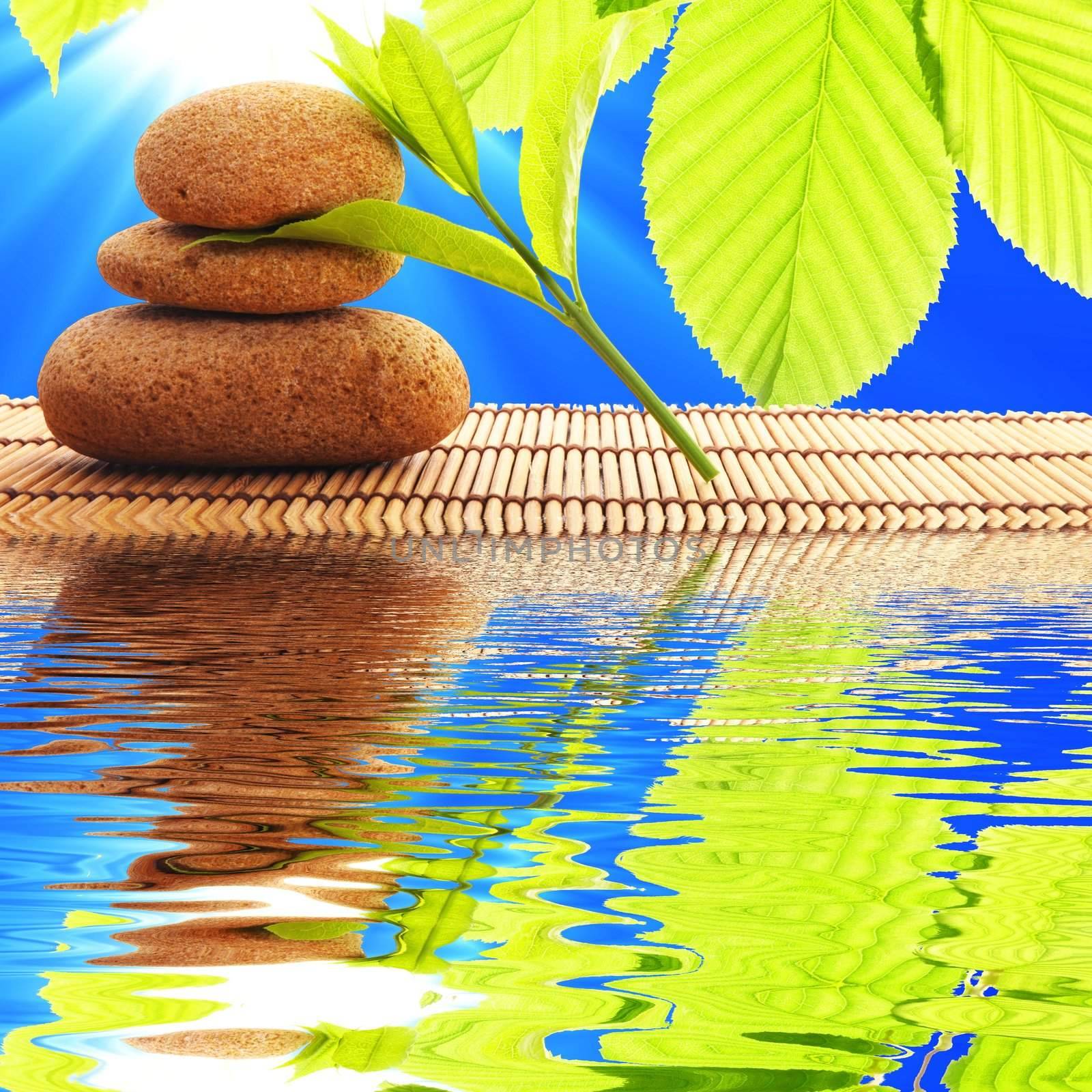 zen stones and water reflection showing spa concept