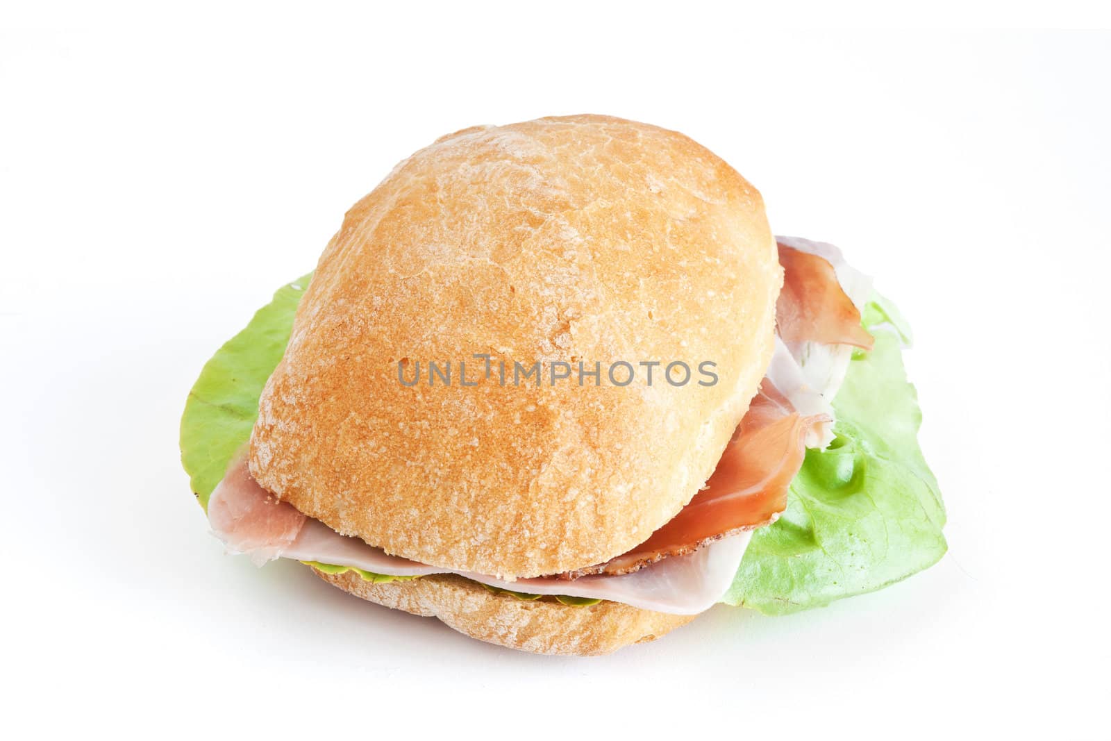 loaf of bread with jam, speck and lettuce isolated on white background