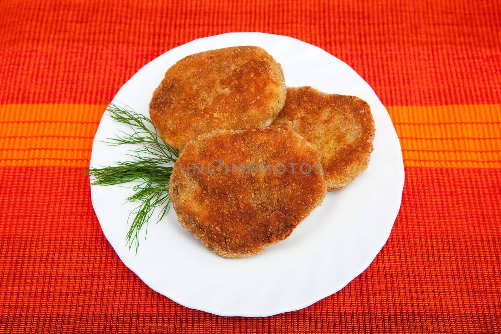 Three cutlets on the white plate