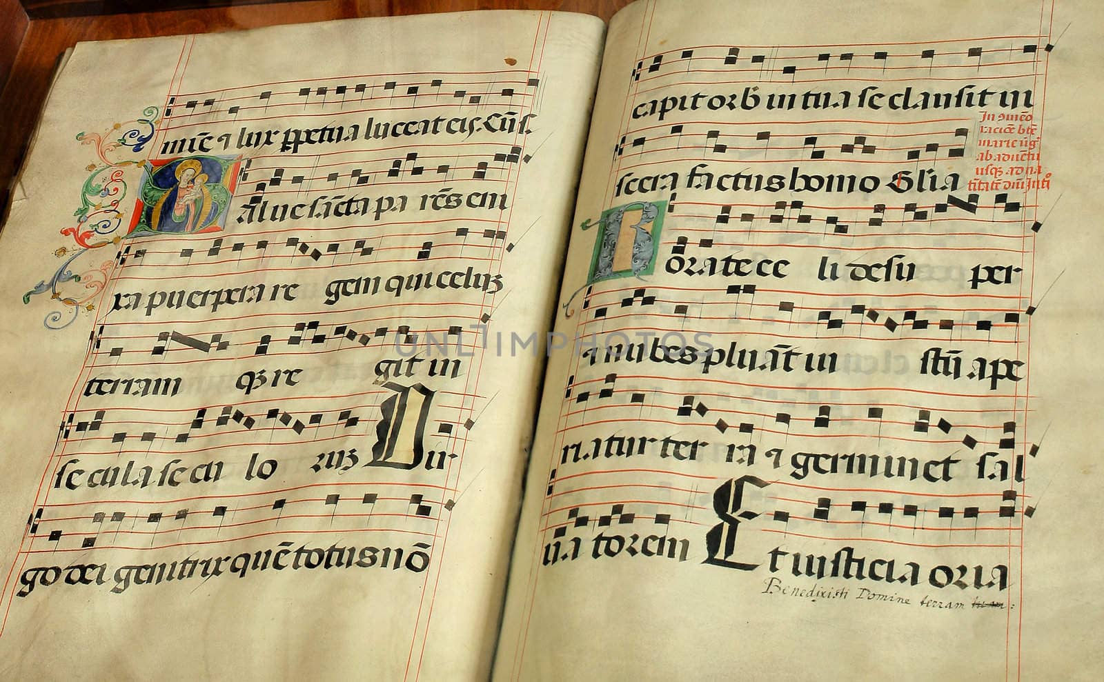 Vintage religious music book with dots and illumination