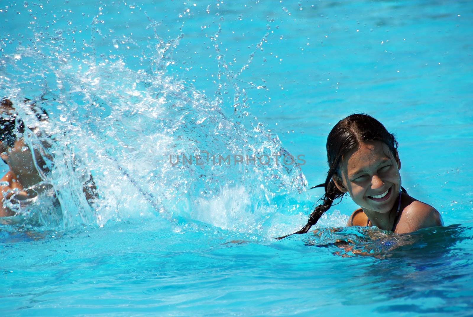 teen girl having fun in swimming pool