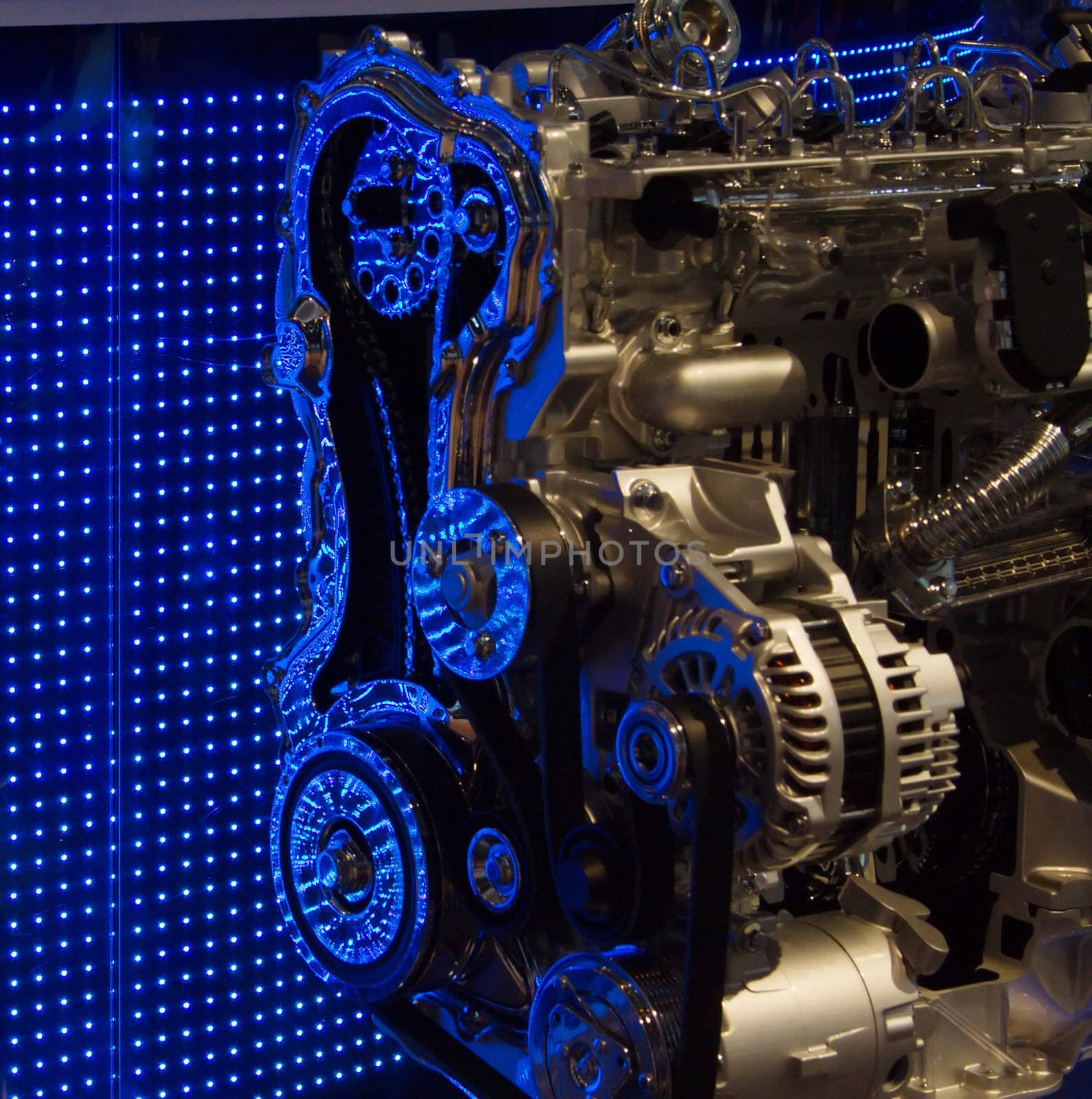 Cut out of motor engine, displayed in front of a blue LED wall