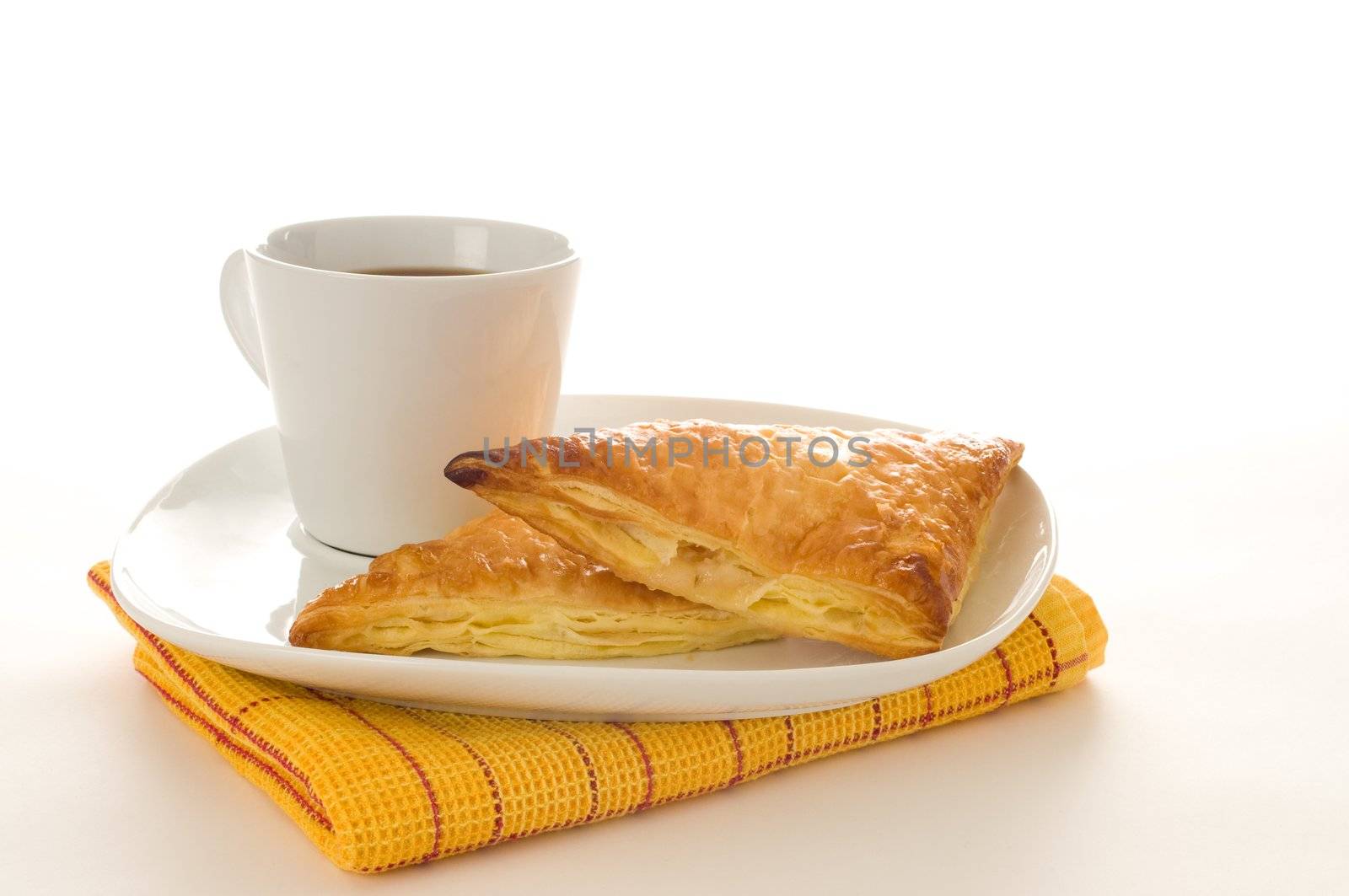 Fresh baked apple turnovers served with coffee.
