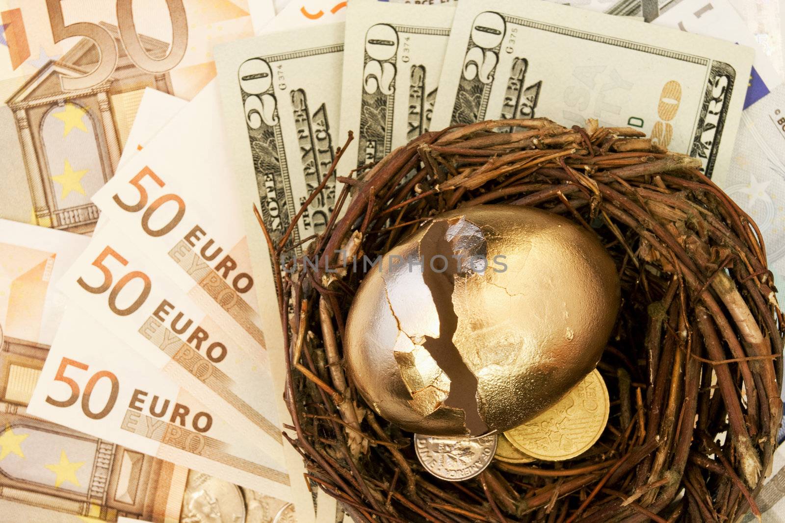Cracked golden egg on European Union and American currencies reflected the damaged value of investments on both sides of the Atlantic